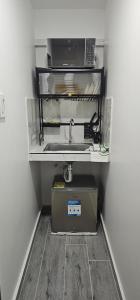 a microwave sitting on a shelf in a room at Balcones de las lajas in Cali
