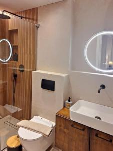 a bathroom with a toilet and a sink and a shower at Aura di centro Thassos in Limenas +10 photos