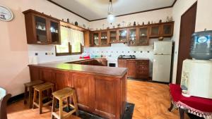 a kitchen with wooden cabinets and a counter top at Villa Kay Serenity in Sampal 2
