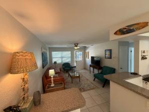 a living room with a kitchen and a living room at Rosewood 1 in Vero Beach