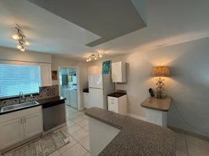 a kitchen with a sink and a counter top at Rosewood 1 in Vero Beach
