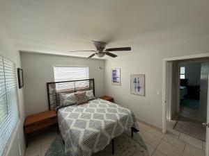 a bedroom with a bed and a ceiling fan at Rosewood 1 in Vero Beach