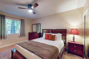a bedroom with a bed and a ceiling fan at Casa Tahquitz in Idyllwild +14 photos