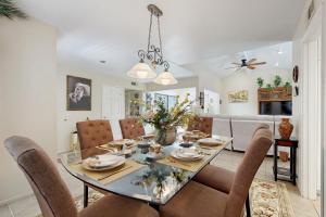 a dining room and living room with a table and chairs at Palm Paradise in Palm Desert