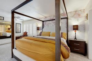 a bedroom with a canopy bed in a room at Palm Paradise in Palm Desert