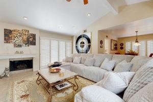 a living room with a couch and a fireplace at Palm Paradise in Palm Desert +33 photos