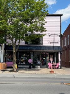 a store with pink flamingos in front of a street at Sleep at Simplicity in Massena