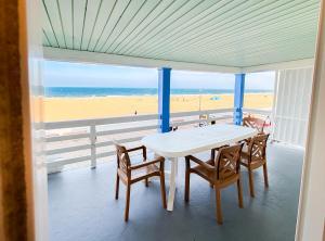 a table and chairs on a balcony with a view of the beach at Majestic Hotel & Apartments in Ocean City