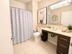 a bathroom with a toilet and a sink and a shower at Spacious, Comfortable, and Central Condo in Los Angeles +10 photos