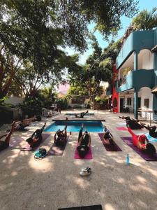 a group of people doing yoga by a swimming pool at Loman Art in Dakar