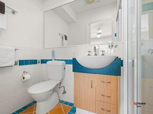 a bathroom with a toilet and a sink at Riverview Apartment 1.4 in Iluka +8 photos