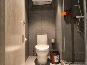 a small bathroom with a toilet and a shower at Orange Hotel Beijing Summer Palace in Beijing +28 photos