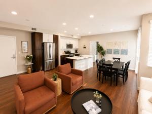 a living room and a kitchen with a table and chairs at Spacious, Comfortable, and Central Condo in Los Angeles