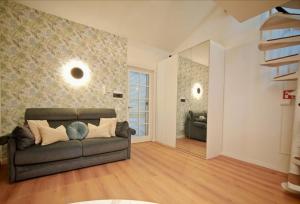 a living room with a brown couch in a room at Tiny Park House in Sabaudia