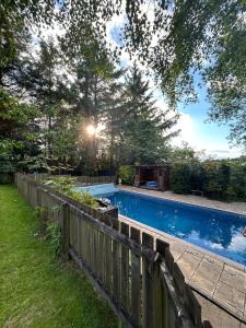 a swimming pool in a yard with a wooden fence at The Cairn in Airdrie
