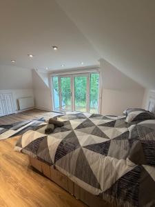 a bedroom with two beds and a large window at The Cairn in Airdrie +54 photos