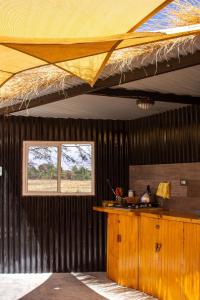 a kitchen with a large ceiling with a window at Atacama Loft & Glamp in San Pedro de Atacama