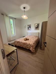 a bedroom with a bed with a teddy bear on it at Chambre privée in Vénissieux +7 photos