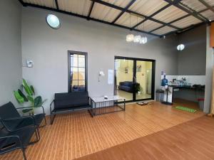 a living room with a couch and a table at Lora House in Sukoharjo
