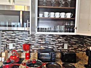 a kitchen with a counter top with a microwave and appliances at Lakeview 2 suites 6 min to New EPIC Universe in Orlando
