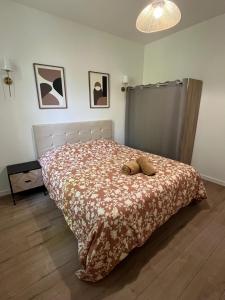a bedroom with a bed with a comforter on it at Chambre privée in Vénissieux