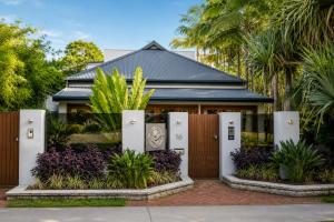 a house with a gate in front of it at Bayhaven Lodge in Byron Bay
