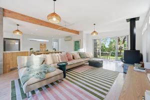 a living room with a couch and a fireplace at Tamara Coastal Retreat in Inverloch