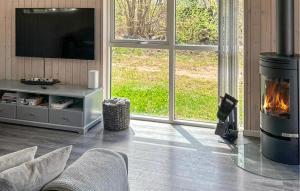 a living room with a fireplace and a tv at Three-Bedroom Holiday Home In Grasted in Græsted