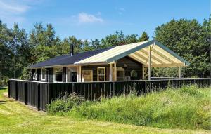a house with a metal roof on top of a field at Cozy Home In Jerup With Wifi in Jerup