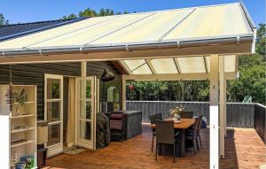 a pavilion on a deck with a table and chairs at Cozy Home In Jerup With Wifi in Jerup