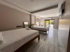a bedroom with two beds and a large window at Torre OCEAN DRIVE in Montañita +53 photos