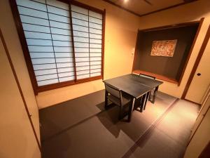 a small room with a table and a window at HOTEL&RESORT Izu no Ne in Higashiizu
