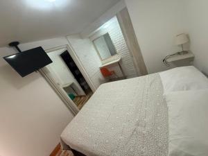 a bedroom with a bed and a room with a window at Le Grey Arica in Arica