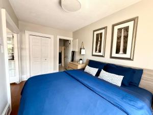 a blue bed with two pillows in a bedroom at Stylish Heritage Gem facing Stewart Park and Town Hall in Perth
