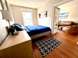 a bedroom with a bed and a living room at Stylish Heritage Gem facing Stewart Park and Town Hall in Perth