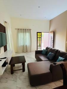 a living room with a couch and a table at "Selva maya stay" kitchen and spacious private parking in Flores