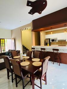 a living room with a table and chairs and a kitchen at "Selva maya stay" kitchen and spacious private parking in Flores