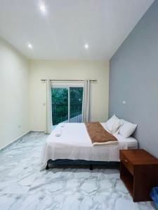 a bedroom with a large bed and a window at "Selva maya stay" kitchen and spacious private parking in Flores