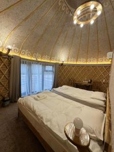 a bedroom with a large bed in a yurt at Tangnuru eco yurts in Bosteri +7 photos