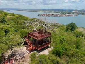 a house on the shore of a body of water at "Selva maya stay" kitchen and spacious private parking in Flores
