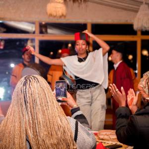 a woman taking a picture of a man dancing at Kal Tenere Luxury Camp in El Karia +108 photos