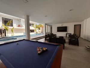 a pool table in a living room next to a pool table at Torre OCEAN DRIVE in Montañita
