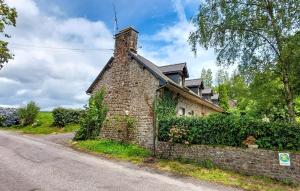 a stone house on the side of a road at Maison Mitoyenne Avec Spa in La Chapelle-Urée +21 photos