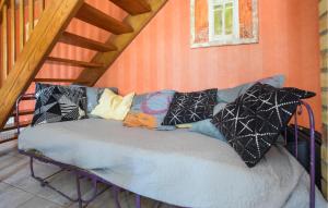 a couch with pillows on it in a room at Maison Mitoyenne Avec Spa in La Chapelle-Urée