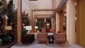 a lobby of a hotel with chairs and a couch at Casa de Sada Algarve Beach Resort, Curio Collection by Hilton in Armação de Pêra