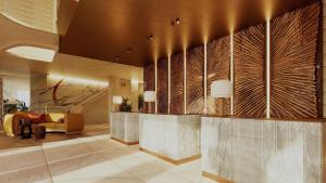 a lobby with a reception desk in a building at Casa de Sada Algarve Beach Resort, Curio Collection by Hilton in Armação de Pêra