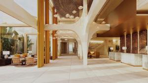 a lobby of a hotel with a large lobby at Casa de Sada Algarve Beach Resort, Curio Collection by Hilton in Armação de Pêra