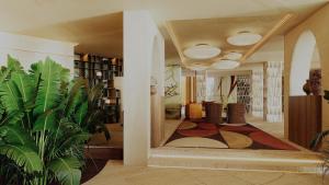 a hallway with a room with plants and a ceiling at Casa de Sada Algarve Beach Resort, Curio Collection by Hilton in Armação de Pêra