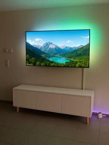 a flat screen tv hanging on a wall at Mountain view in Martigny-Ville