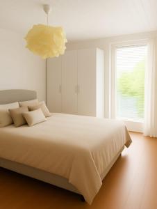 a bedroom with a large bed and a large window at Mountain view in Martigny-Ville